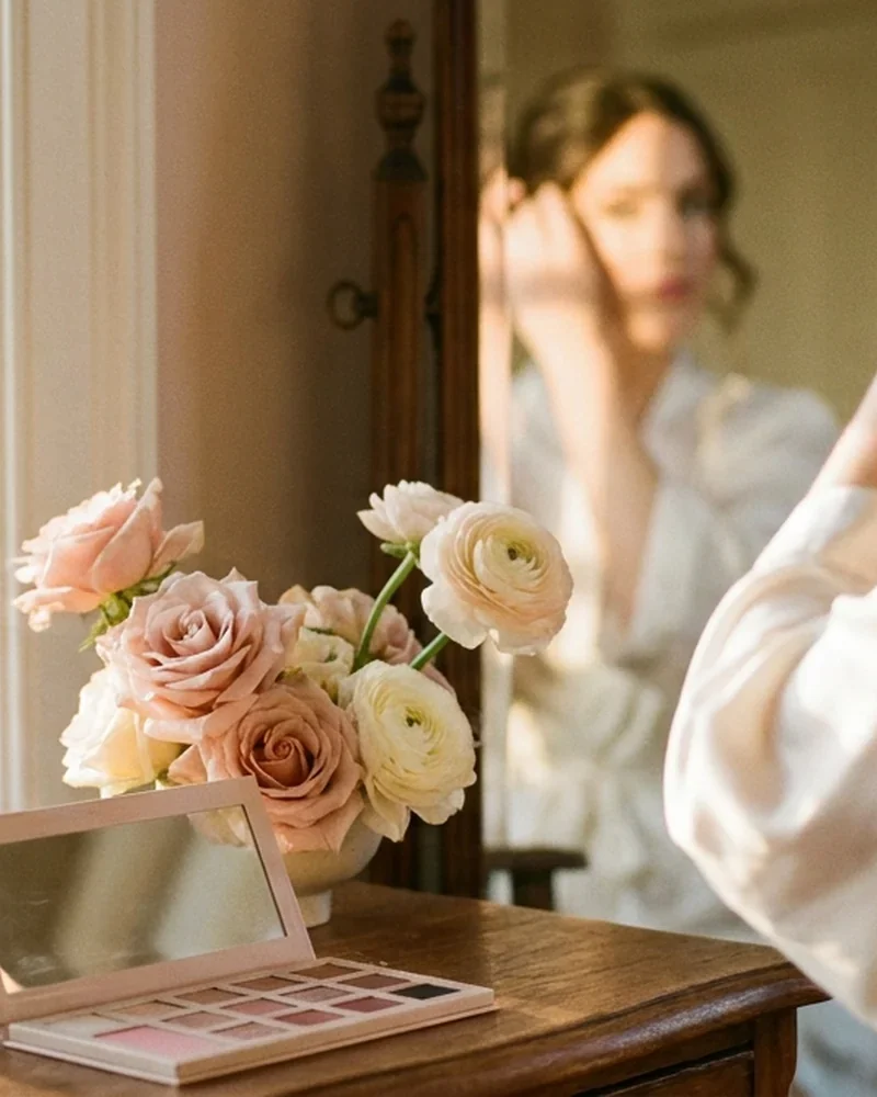 An Adelaide bridal vanity with makeup brushes and blush florals at golden hour